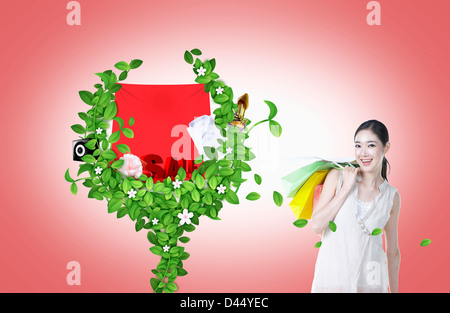 Una donna con un alfabeto verde forma a y con un segno di vendita su Foto Stock