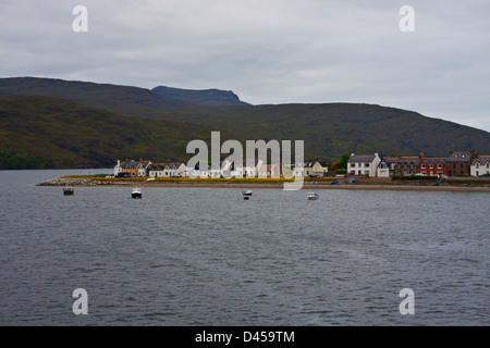 Un lungo spiedo di sabbia che forma il braccio del porto a Ullapool è rivestito con case. Foto Stock