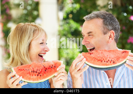 Madre e figlia adulta godendo le fette di melone acqua Foto Stock