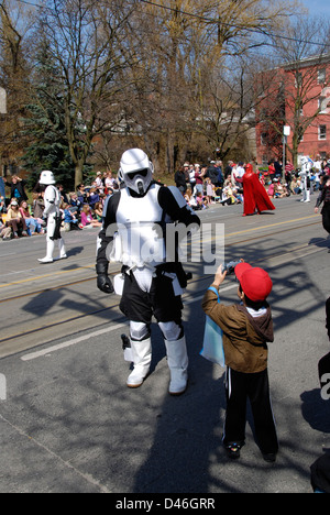 Un giovane ragazzo scatta una foto di un uomo vestito in una Star Wars stormtrooper costume di una comunità parade. Foto Stock