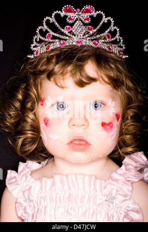 La ragazza con la faccia vernice in princess tiara Foto Stock