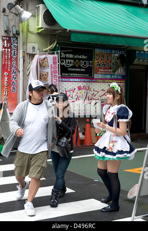 Ragazze vestite di cameriera francese costumi distribuivano buoni sconto per Maid Cafe di Tokyo di Akihabara il quartiere del divertimento. Foto Stock