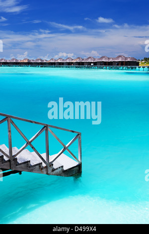 Passi in incredibile laguna blu con bungalow sull'acqua Foto Stock