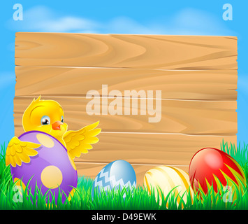Giallo di pollo di Pasqua e dipinte di cioccolato uova di Pasqua con un fustellato cartello in legno per il tuo messaggio Foto Stock