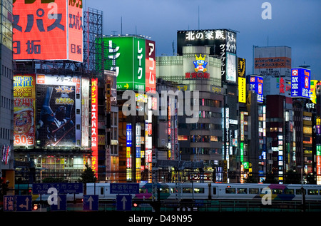 Il Neon cartelli pubblicitari sulle facciate di edifici illumina di sera a shopping e intrattenimento per adulti quartiere di Kabukicho a Tokyo. Foto Stock