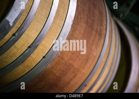 Una chiusura di una botte di vino impilati nella cantina dell'azienda vinicola in Australia. (Fuoco selettivo) Foto Stock