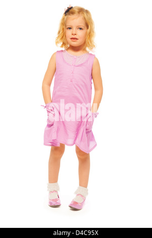 Carino bionda bambina in piedi isolato su bianco Foto Stock