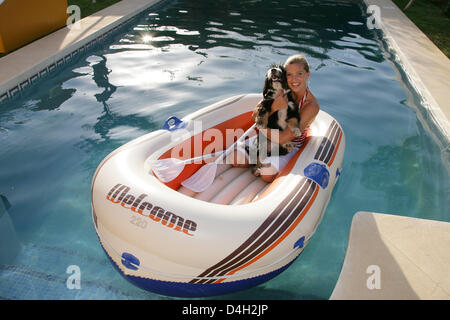 Maja Synke Principessa di Hohenzollern si siede in un gommone con lei il suo cane "Klitschko' in un giardino in Marbella, Spagna, 26 luglio 2008. Maja di Hohenzollern vive attualmente in una casa in Andalusia con cinque cani, cinque cuccioli e due gatti, che ella ha salvato dalla strada o la stazione di uccisione. Maja di Hohenzollern vende la sua progettata lussuosamente case di animale e di letti su inte Foto Stock