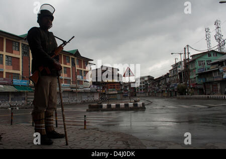 Srinagar, Indiano Kashmir amministrato, giovedì 14 marzo 2013. La polizia indiana uomo protezioni strade deserte durante un coprifuoco a Srinagar la capitale estiva di Indiano Kashmir amministrato, India. Le autorità indiane ha imposto il coprifuoco in Kashmir per contrastare la manifestazione di protesta dopo che hanno ucciso un 34 anno vecchio mercoledì. Foto di Sofi Suhail/Alamy) Foto Stock