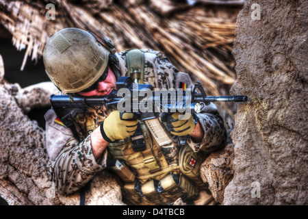 High Dynamic Range Immagine di un esercito tedesco soldato armato di un m4 carbine fucile da assalto sulle rovine di un edificio afghano. Foto Stock