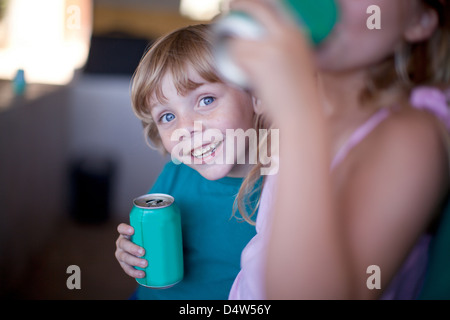 I bambini a bere soda in garage Foto Stock