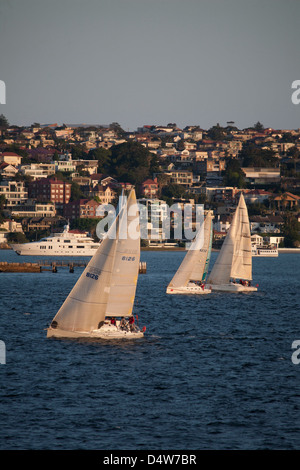 Mercoledì pomeriggio regata nautica passando davanti a luxury waterfront case sobborghi orientali Sydney Australia Foto Stock