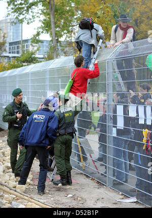 Gli avversari del controverso le costruzioni ferroviarie progetto Stuttgart 21 scavalchino i recinti che proteggono il cantiere di fronte alla stazione centrale di Stoccarda (Germania), 30 ottobre 2010. I manifestanti hanno poi sono andato su un impianto di nuovi alberi in sostituzione di quelli che sono stati abbattuti all inizio di ottobre. Foto: Bernd Weissbrod Foto Stock