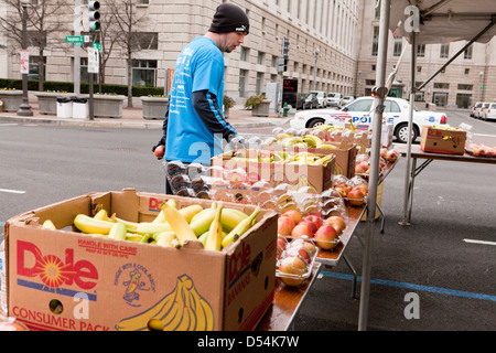 Il maratoneta raggiungendo per la frutta dopo gara Foto Stock