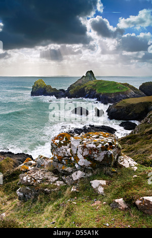 Raggi di sole al largo della costa di Kynance Cove Beach, Cornwall Foto Stock