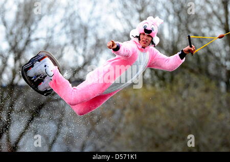 Il tedesco wakeboarder Rene Konrad, mondo secondo in classifica il 'Open Uomini' categoria, esegue un salto sul suo wakeboard indossando un rosa Easter Bunny costume in Amburgo, Germania, 04 aprile 2010. Konrad si prepara per il wakeboard campionati del mondo che si svolgerà in Neubrandenburg, Germania questo summmer. Egli indossava il costume in occasione dell apertura del centro sci nautico ho Foto Stock