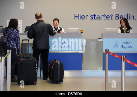 Due Air Berlin i passeggeri effettuano il check in presso l'aeroporto Tegel di Berlino, Germania, 19 aprile 2010. Ceneri vulcaniche da una eruzione in Islanda continuano ad interrompere il traffico aereo in ampie parti dell'Europa, lo spazio di aria rimane chiuso. Tuttavia vettori tedesca Lufthansa e Air Berlin hanno ripreso alcuni dei loro voli, il loro svolgimento in visual regole del volo. Nel frattempo la Germania il controllo del traffico aereo Foto Stock