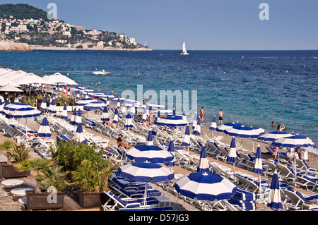 Spiaggia privata con blue ombrelloni da spiaggia, mare sullo sfondo vista da sopra - Nizza, Francia Foto Stock