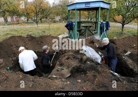 I membri del personale del cimitero di guerra tedesco associazione aiuti a recuperare i resti di soldati tedeschi dalla II guerra mondiale in Glasunovka, Russia, 17 ottobre 2009. Alcuni 1700 soldati sono stati sepolto al cimitero di divisione e verrà ora trasferito in un cimitero collettivo in Besedino. La maggior parte dei soldati morti in battaglia di Kursk nel 1943 che è considerata la più grande battaglia del serbatoio della guerra Foto Stock