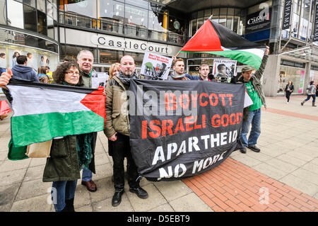 Belfast, Irlanda del Nord. 30th marzo 2013. Manifestanti pro-palestinesi dimostrano fuori Castlecourt Shopping Centre dove un negozio sta vendendo prodotti cosmetici israeliani. Nel colpo sono inclusi l'autore e l'attivista palestinese fra Hughes (indossando una giacca beige). Credit: Stephen Barnes / Alamy Live News Foto Stock