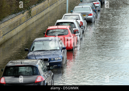 Auto parcheggiate in allagato suburban Road Londra Foto Stock