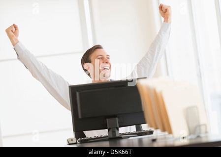 Lavoratore di ufficio il tifo nella parte anteriore del computer Foto Stock