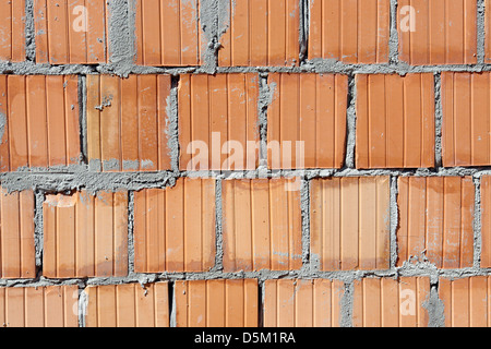 Primo piano dello stato grezzo rosso parete di mattoni Foto Stock