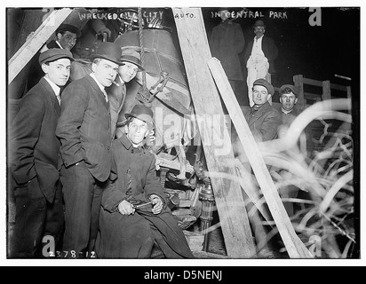 Questa fotografia in bianco e nero mostra un'automobile distrutta a Central Park, New York, dei primi anni del XX secolo. L'immagine cattura le conseguenze di un incidente e offre uno sguardo sulla vita urbana e sulla storia delle prime automobili di New York. Foto Stock