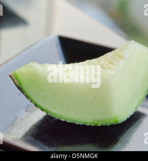 Unico melone fette di melone sul piatto . Foto Stock