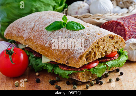La ciabatta in sandwich con salame, formaggio e verdure Foto Stock