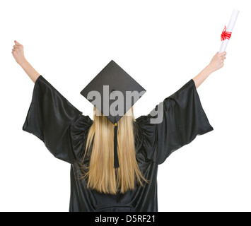 Donna in abito di graduazione esultanza successo . vista posteriore Foto Stock