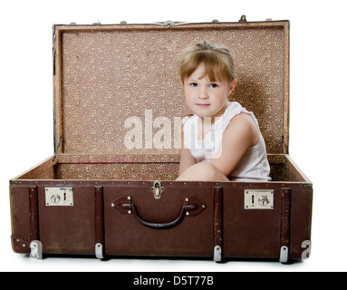 La bambina in una vecchia valigia isolato Foto Stock