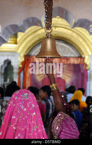 I credenti suonare una campana al momento di entrare in un tempio indù a Jaipur, India, 16 novembre 2012. Foto: Jens Kalaene Foto Stock