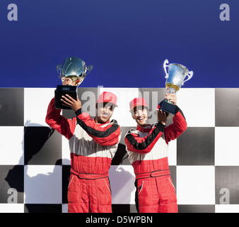 Racers tenendo i trofei alla cerimonia di premiazione Foto Stock