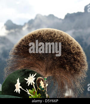 I partecipanti del XXVI Gamsbart Olimpiadi (lit. camosci barba olimpiadi) attendere per la cerimonia di premiazione e godere della vista di Karwendel mountain range in Mittenwald, Germania, 14 ottobre 2012. Fino a 100 partecipanti provenienti da diverse aree Apline hanno partecipato all'evento. Foto: Frank Leonhardt Foto Stock