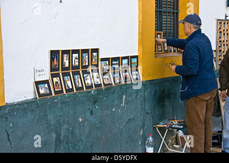 Street artista pittore vendita quadri arte in Santa Cruz Siviglia Andalusia Andalusia Spagna Europa Foto Stock