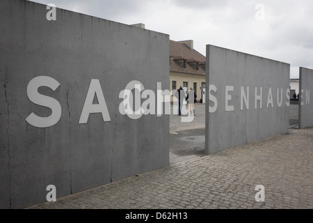 Un turista giovane immettere il Sachsenhausen Memorial e Museo. Sachsenhausen è stato un nazista e sovietica del campo di concentramento di Oranienburg, 35 chilometri (22 miglia) a nord di Berlino, Germania, utilizzato principalmente per i prigionieri politici dal 1936 alla fine del terzo Reich nel maggio 1945. (Più didascalia nella descrizione). Foto Stock