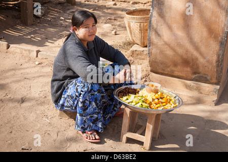 Donna di vendita di alimenti in un mercato all'aperto, Bagan, Myanmar (Birmania) Foto Stock