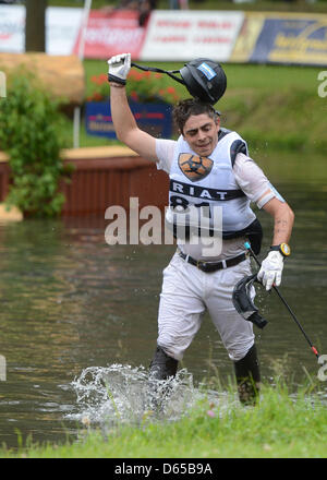 L'argentino cross country rider Jose Luis Ortelli timbri i suoi piedi arrabbiato in una pozza dopo essere stato buttato fuori il suo cavallo Jos Cassio durante il tedesco Eventing Championships di Luhmuehlen, Germania, 16 giugno 2012. Foto: Jochen Luebke Foto Stock