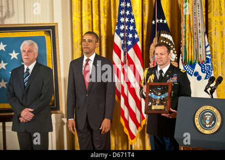 Il Presidente Usa Barack Obama awards medaglia d'onore di US Army Cappellano Capt. Emil Kapaun, accettato postumi da suo nipote di Ray, sinistra, durante una cerimonia che si terrà nella Sala Est della Casa Bianca, 11 aprile 2013 a Washington, DC. Padre Kapaun è stato onorato per il suo eroismo durante il combattimento a Unsan, Corea e più tardi morì come prigioniero di guerra. Foto Stock