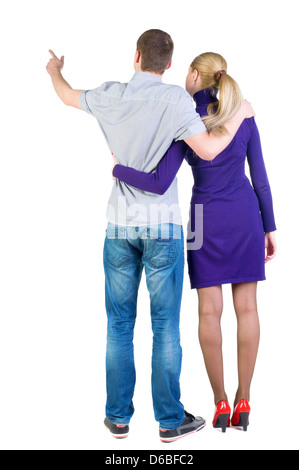 Coppia giovane è rivolta a parete. Vista posteriore (donna e uomo). Ragazzo in jeans e maglietta e una ragazza in vestito blu. Foto Stock