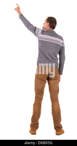 Vista posteriore di puntamento di giovani uomini in maglione e jeans. Giovane ragazzo gesti. Vista posteriore di raccolta di persone. Vista posteriore di persona. Foto Stock