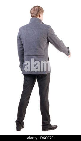 Vista posteriore di imprenditore nel rivestire raggiunge fuori per agitare le mani. fissato un uomo che vi accoglie. Vista posteriore di raccolta di persone. Foto Stock