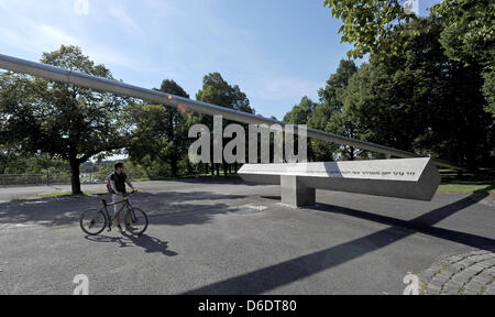 I visitatori guardano il memoriale per le vittime dell attentato terroristico durante il 1972 in occasione dei Giochi Olimpici di Monaco di Baviera su una piazza in Olympiapark a Monaco di Baviera, Germania, il 29 agosto 2012. Undici atleti israeliani, un funzionario di polizia e palestinese cinque rapitori furono uccisi in attacco e la presa di ostaggi che ha avuto luogo il 5 settembre 1972. Foto: Tobias Hase Foto Stock