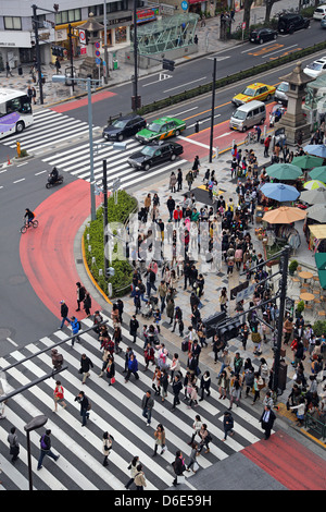 Scena di strada che mostra una folla di persone che attraversano la strada a un attraversamento pedonale in Harajuku, Tokyo, Giappone Foto Stock
