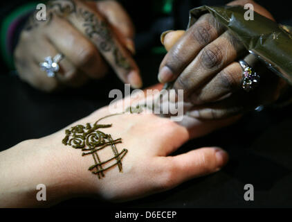 La mano di un visitatore è decorata con henna al Pergamon Museum di Berlino, Germania, 25 gennaio 2012. La tipica decorazione arabo viene offerto ai visitatori per la mostra "strade di Arabia. Tesori archeologici dall Arabia Saudita', che è aperta fino al 09 aprile 2012. Foto: STEPHANIE PILICK Foto Stock