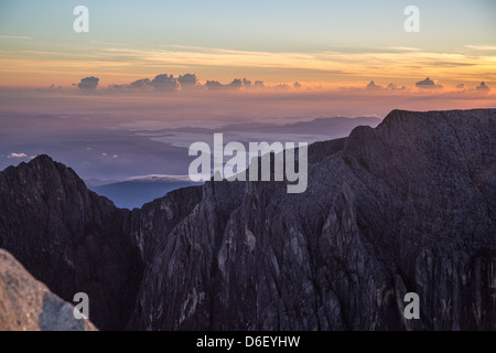 Alba sul basso burrone di un vasto tenebroso voragine nei fianchi di Gunung Kinabalu Sabah Borneo visto dal basso il vertice di picco 4095m Foto Stock