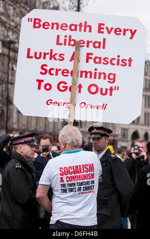 Londra, UK, 17 apr. 2013. Servizio funebre della Baronessa Thatcher avviene alla cattedrale di San Paolo. Migliaia di persone lungo le strade per pagare i loro aspetti come la bara, drappeggiati in la bandiera dell'Unione, è trasportato su un carrello della pistola con gli onori militari. L'uomo nella foto paga i suoi rispetti effettuando un segno opposto del socialismo e del comunismo. Foto Stock