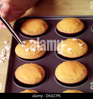 Rendendo tortini di Halloween - decorare le tortine - passo shot Foto Stock