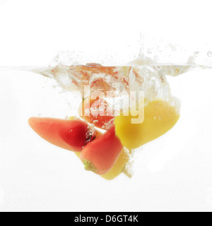 Colorato Chili Peppers schizzi in acqua Foto Stock